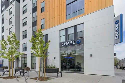 Modern building entrance with Chase bank exterior at IDENTITY Logan Park in Berkeley Student Accommodation
