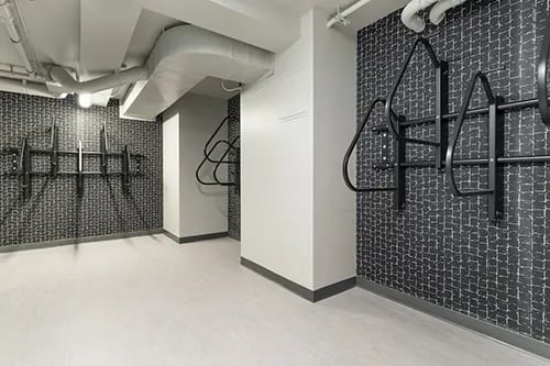 Bike racks on patterned wall common area at IDENTITY Logan Park in Berkeley Student Accommodation