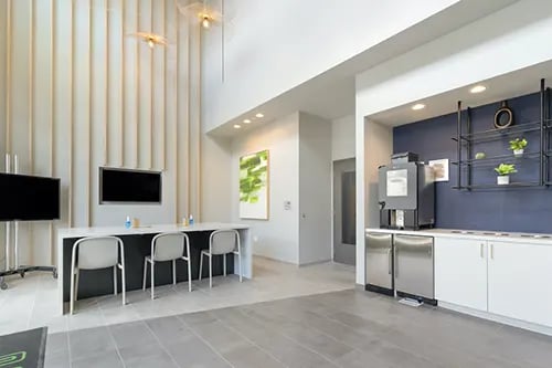 Modern lounge area with coffee station and seating living room at IDENTITY Logan Park in Berkeley Student Accommodation