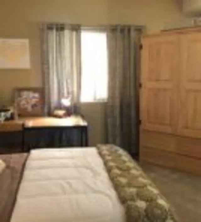 Bed desk window closet bedroom at GrandMarc at University Village in Riverside Student Accommodation