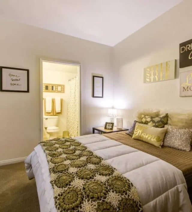 Bed with blankets and pillows a bathroom visible bedroom at GrandMarc at University Village in Riverside Student Accommodation