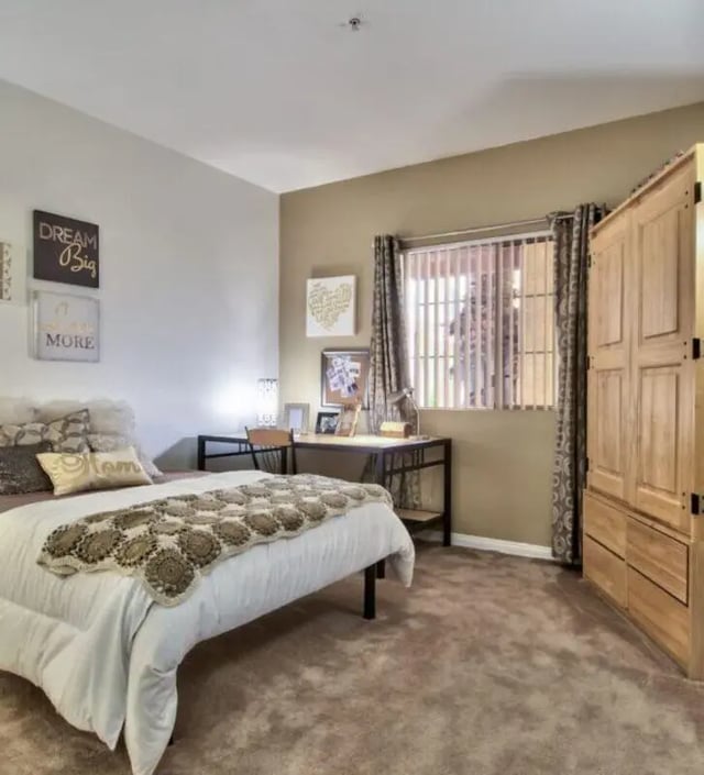 Bed desk wardrobe and decorative pillows bedroom at GrandMarc at University Village in Riverside Student Accommodation