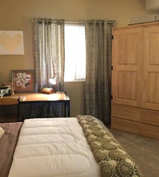 Bed desk lamp closet and bed bedroom at GrandMarc at University Village in Riverside Student Accommodation