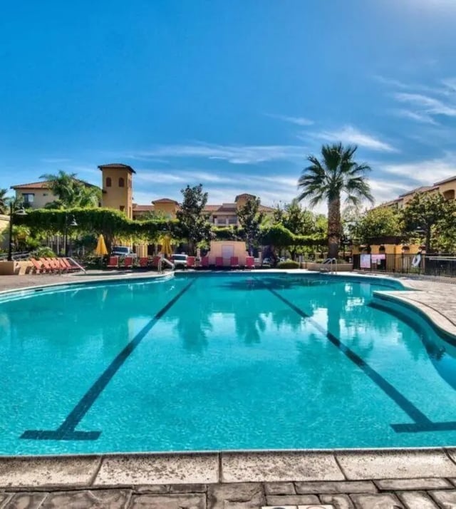 Large blue swimming pool with lounge chairs exterior at GrandMarc at University Village in Riverside Student Accommodation