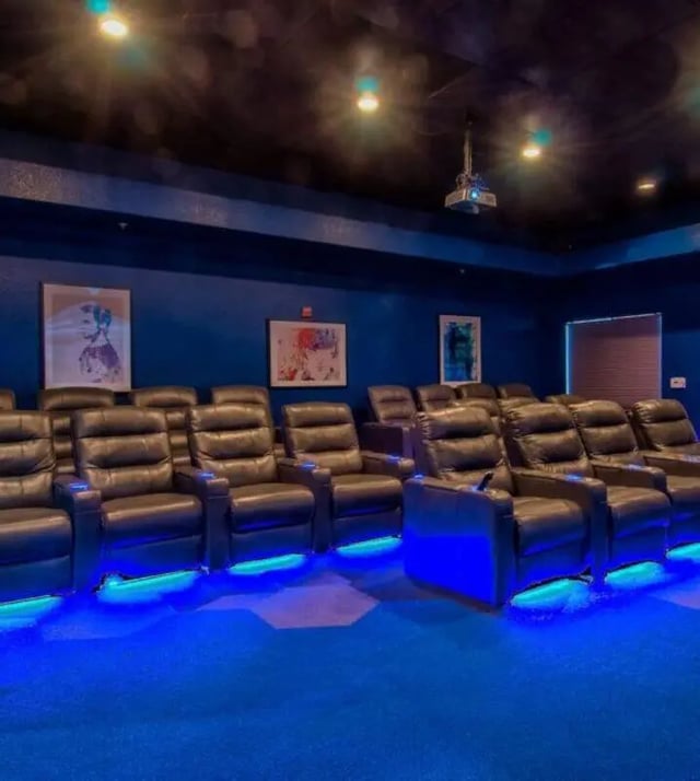 Leather recliners with blue underglow theater at GrandMarc at University Village in Riverside Student Accommodation