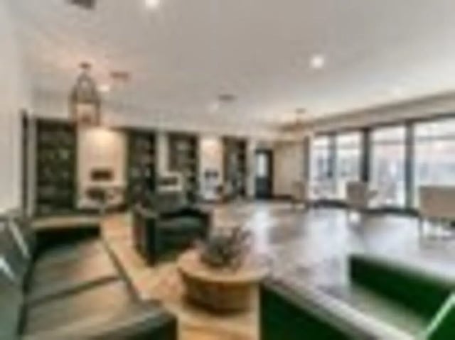 Large modern living room with sectional sofas living room at The Grove Apartments Ames in Ames Student Accommodation