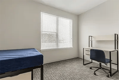 Bed and desk with chair bedroom at Uncommon Wilmington in Wilmington Student Accommodation