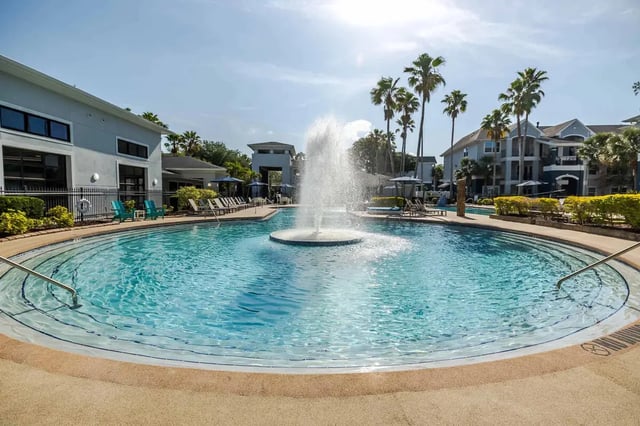 Swimming pool with fountain lounge chairs exterior at The Verge in Orlando Student Accommodation