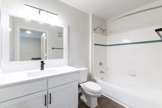 White vanity toilet and bathtub bathroom at Grandmarc at The Corner in Charlottesville Student Accommodation