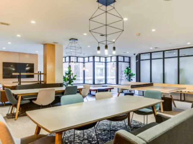 Tables chairs plants ping pong table common area at Grandmarc at The Corner in Charlottesville Student Accommodation