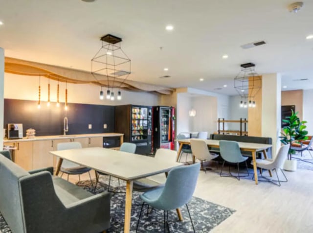 Kitchen area with seating vending machines and sink kitchen at Grandmarc at The Corner in Charlottesville Student Accommodation