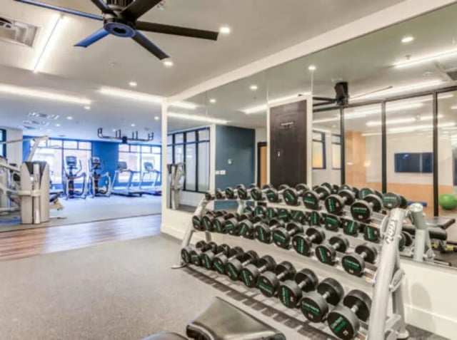 Dumbbells and treadmills in a modern gym playing area at Grandmarc at The Corner in Charlottesville Student Accommodation