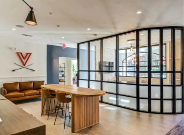 Sofa and island bar with stools communal area at Grandmarc at The Corner in Charlottesville Student Accommodation