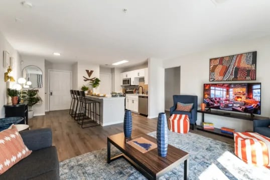 Living area with kitchen bar and television living room at Grandmarc at The Corner in Charlottesville Student Accommodation