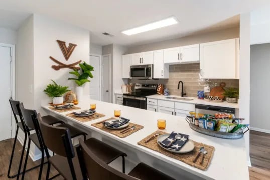 Island kitchen with four bar stools and snacks kitchen at Grandmarc at The Corner in Charlottesville Student Accommodation