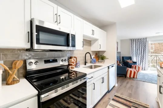 White kitchen with stainless steel appliances kitchen at Grandmarc at The Corner in Charlottesville Student Accommodation