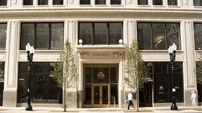 Ornate building entrance with windows and trees exterior at INFINITE in Chicago Student Accommodation
