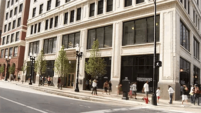Building exterior with people walking on sidewalk exterior at INFINITE in Chicago Student Accommodation
