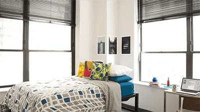 Bed with pillows and artwork bedroom at INFINITE in Chicago Student Accommodation