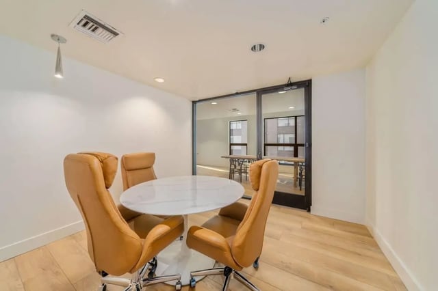 Round table brown chairs glass wall study area at Malibu Tucson Apartments in Tucson Student Accommodation