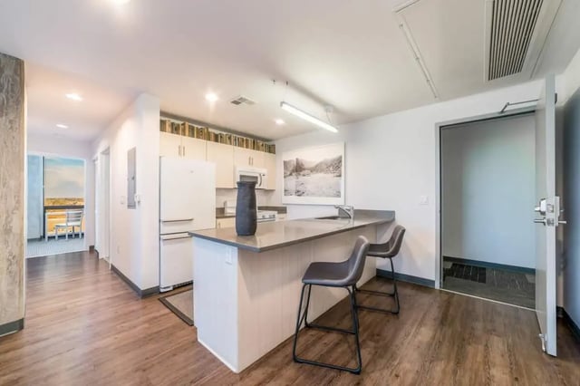 Kitchen with island bar stools and appliances kitchen at Malibu Tucson Apartments in Tucson Student Accommodation