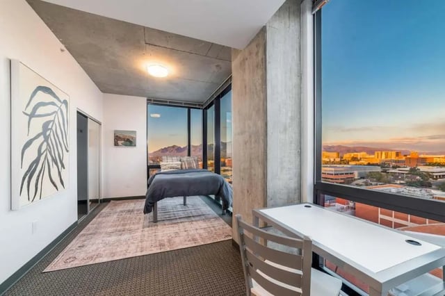 Bed rug artwork and desk bedroom at Malibu Tucson Apartments in Tucson Student Accommodation