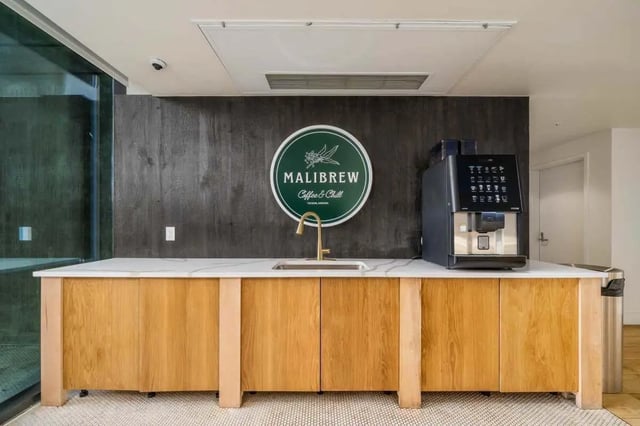 Coffee machine sink and wooden cabinets communal kitchen at Malibu Tucson Apartments in Tucson Student Accommodation