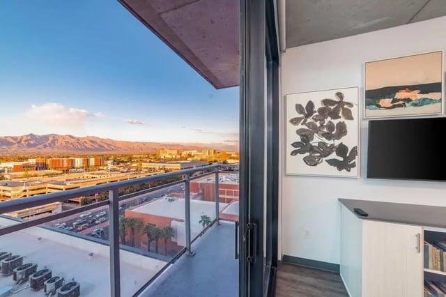 Balcony with city view artwork and TV Living room at Malibu Tucson Apartments in Tucson Student Accommodation