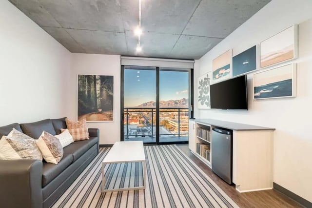 Sofa coffee table TV and mountain view living room at Malibu Tucson Apartments in Tucson Student Accommodation