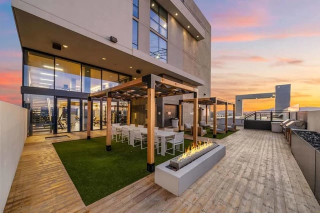 Rooftop patio with fire pit dining tables and gym exterior at Malibu Tucson Apartments in Tucson Student Accommodation