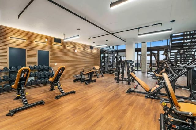 Weight racks benches and exercise machines gym interior at Malibu Tucson Apartments in Tucson Student Accommodation