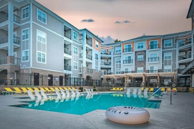 Apartment buildings with pool and lounge chairs exterior at The Eastern On 10th in Greenville Student Accommodation