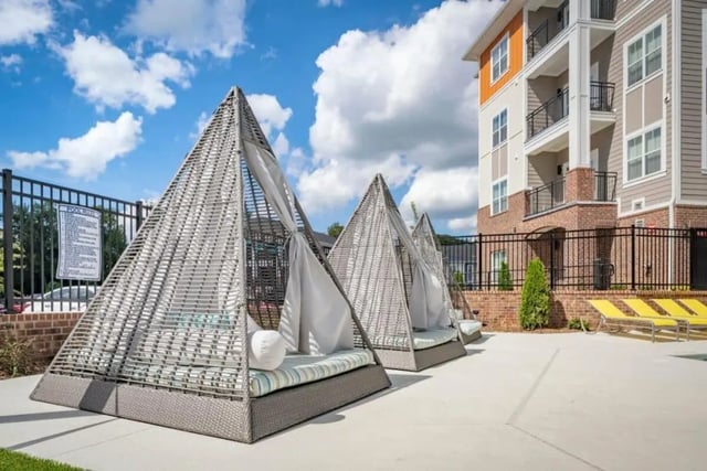 Pyramid cabanas with cushions and curtains outdoor seating area at The Eastern On 10th in Greenville Student Accommodation