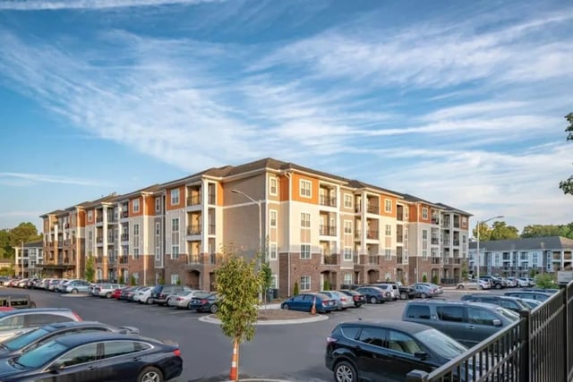 Apartment building with many parked cars exterior at The Eastern On 10th in Greenville Student Accommodation