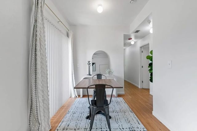Dining table chairs rug mirror study area at Green Spring in San Marcos Student Accommodation