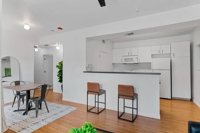 Dining area and kitchen with bar stools kitchen at Green Spring in San Marcos Student Accommodation