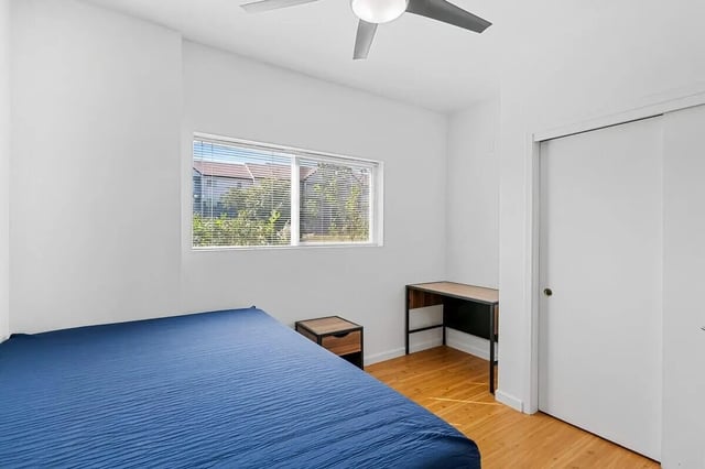 Blue bed desk nightstand closet bedroom at Green Spring in San Marcos Student Accommodation