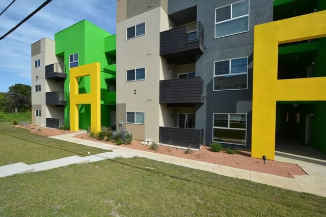 Colorful apartment building with balconies exterior at Green Spring in San Marcos Student Accommodation