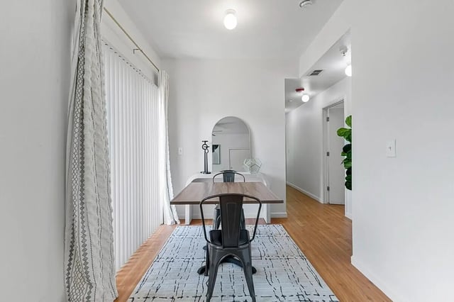 Table chairs rug mirror hallway dining area at Green Spring in San Marcos Student Accommodation
