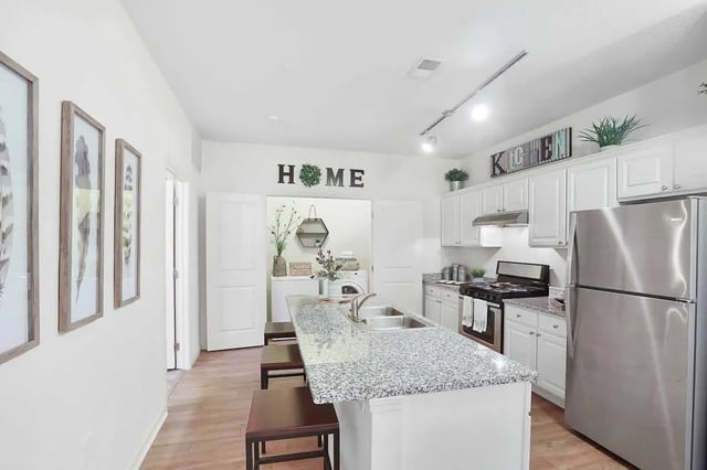 Kitchen island granite counters stove refrigerator kitchen at Greene crossing flats in Columbia Student Accommodation