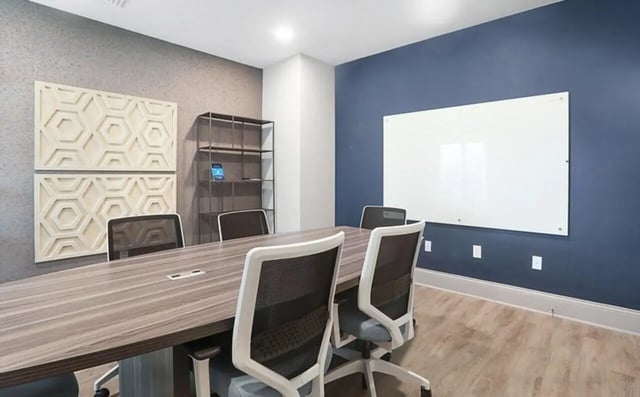Conference table chairs whiteboard shelves study area at Greene crossing flats in Columbia Student Accommodation
