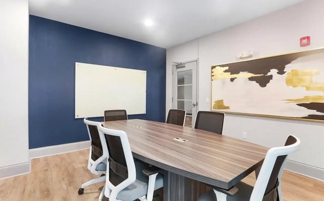 Conference table with chairs whiteboard abstract art Study area at Greene crossing flats in Columbia Student Accommodation