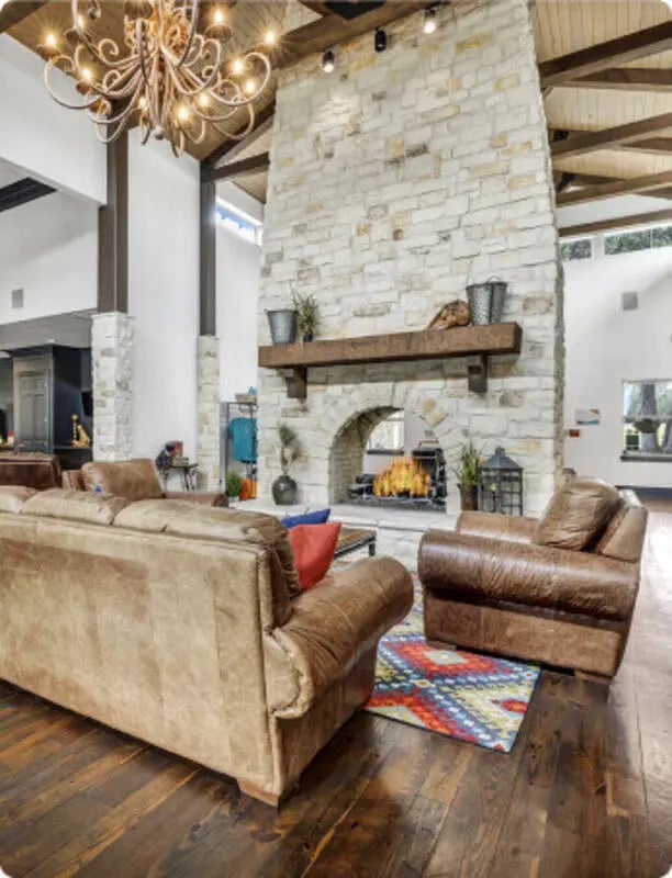 Leather sofas armchairs fireplace living room at The Ranch Student Apartments in San Marcos Student Accommodation