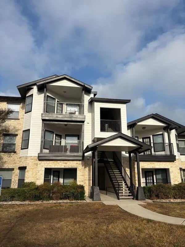 Apartment building with balconies and stairs exterior at The Ranch Student Apartments in San Marcos Student Accommodation