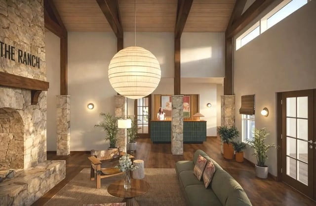 Stone fireplace sofa armchair large lamp lobby at The Ranch Student Apartments in San Marcos Student Accommodation