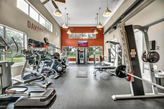 Weight machines treadmills exercise bikes gym interior at The Ranch Student Apartments in San Marcos Student Accommodation