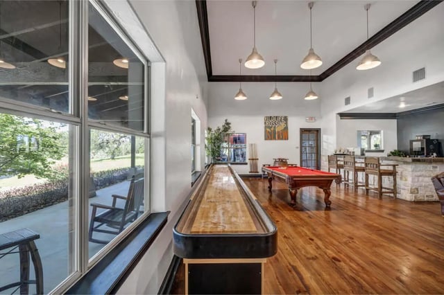 Shuffleboard table billiard table bar area game room at The Ranch Student Apartments in San Marcos Student Accommodation