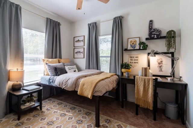 Bed with yellow blanket and side table bedroom at The Ranch Student Apartments in San Marcos Student Accommodation
