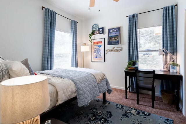 Bed with blue quilt desk with lamp bedroom at The Ranch Student Apartments in San Marcos Student Accommodation