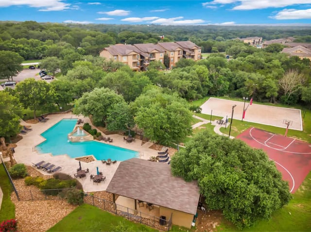 Apartment buildings pool volleyball court basketball court exterior at The Ranch Student Apartments in San Marcos Student Accommodation